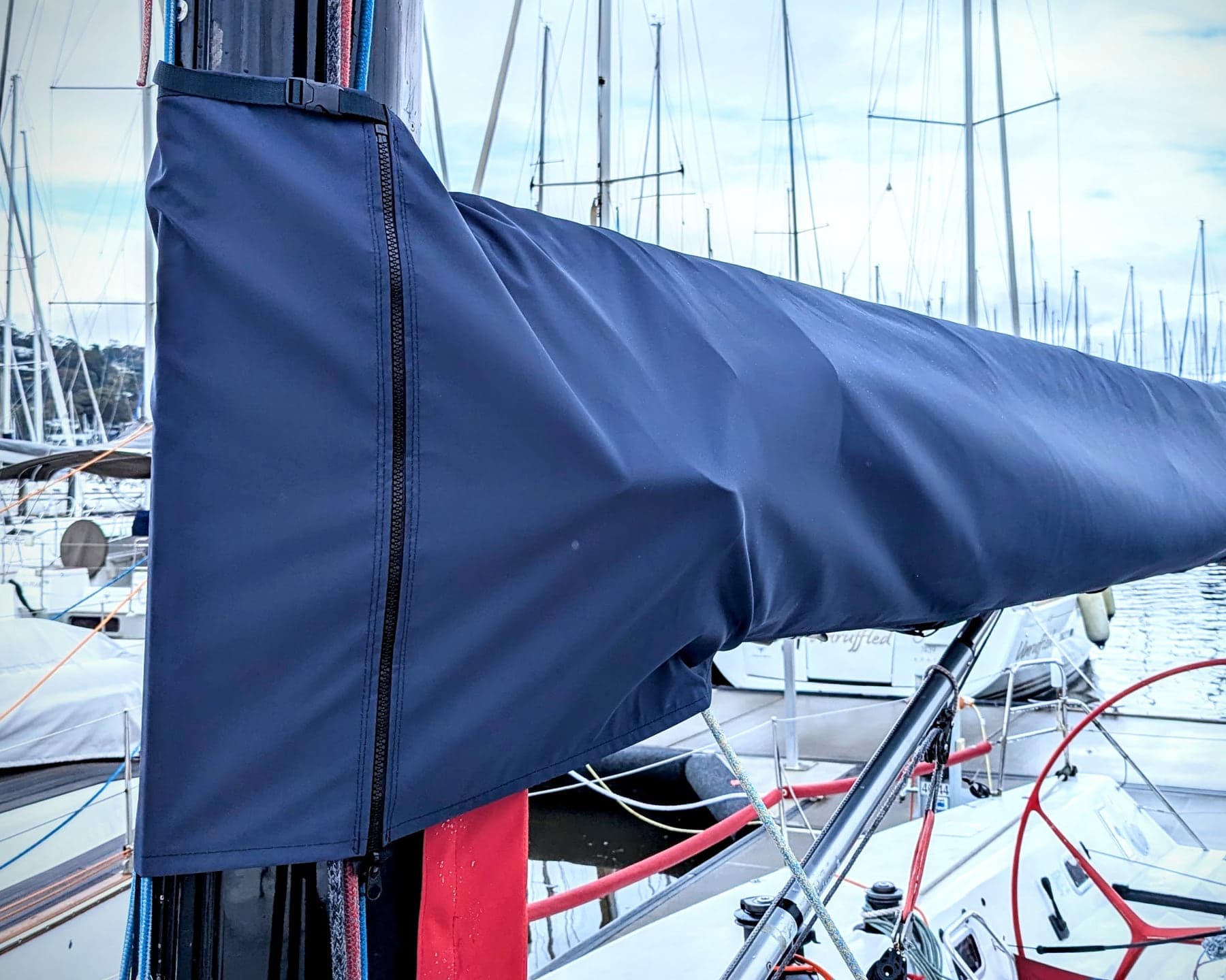 Boom cover with a forward zip and underside clips